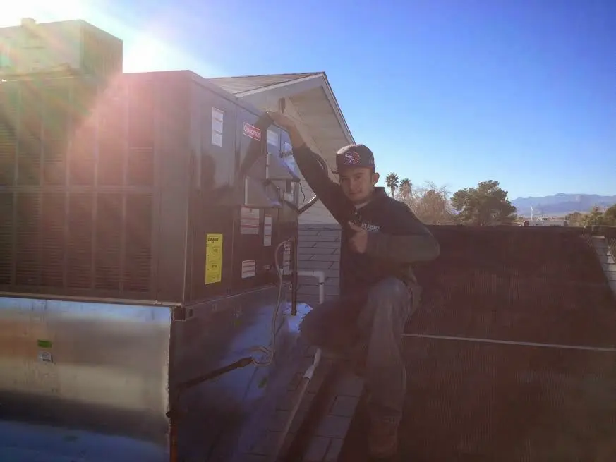 HVAC technician performing HVAC Inspection on a rooftop unit in Lamesa